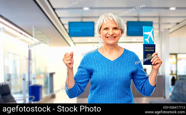 senior woman with immunity passport and air ticket