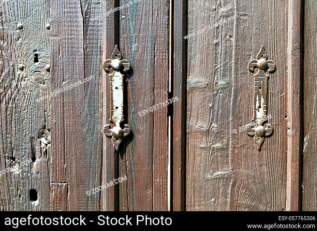 castellanza blur lombardy  abstract  rusty brass brown knocker in a door curch closed wood italy  cross