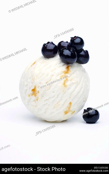 One scoop of crÃ¨me-double ice cream with blueberry compote