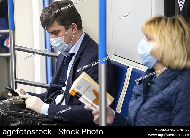 (200512) -- MOSCOW, May 12, 2020 (Xinhua) -- Passengers wearing face masks and gloves are seen on a subway train in Moscow, Russia, on May 12, 2020