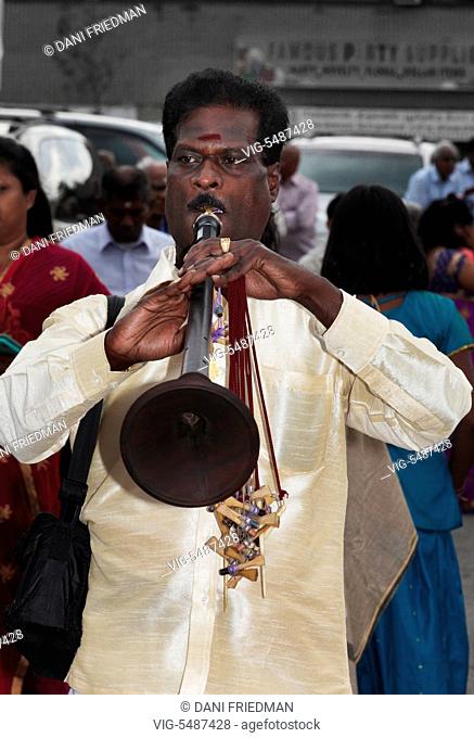 CANADA, SCARBOROUGH, 11.09.2015, A Tamil Hindu musician playing Naathaswaram as he leads the procession during the Chariot festival of Kandaswamy (Lord Murugan)...