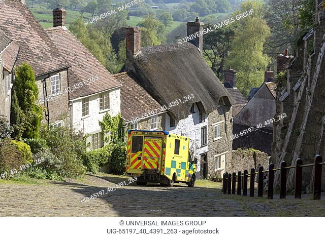 Shaftesbury, Dorset, England, UK. April 2019. An ambulance on Gold Hill a scenic rural location in England
