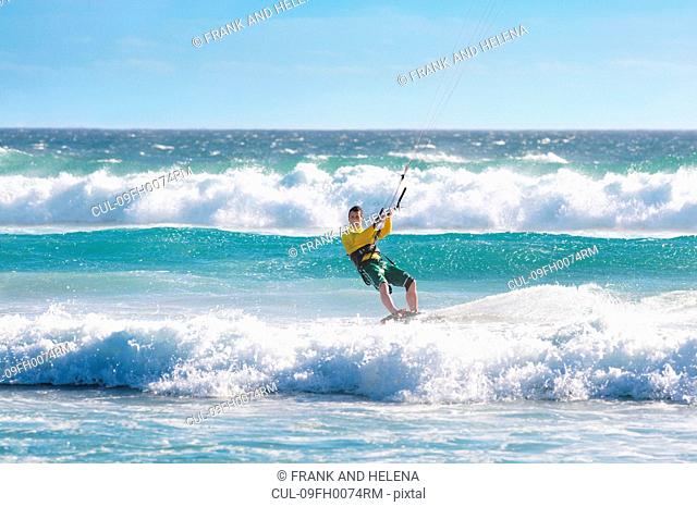 Man kitesurfing in heavy sea