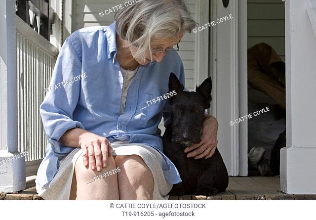Woman and Scottish Terrier enjoying a sunny summer morning on the porch  MR & PR