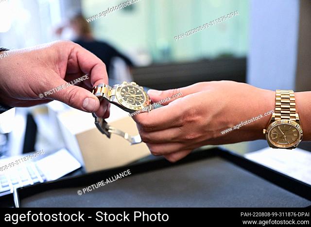 PRODUCTION - 02 August 2022, Baden-Wuerttemberg, Stuttgart: A luxury watch is pawned at the Stuttgart Municipal Pawnshop