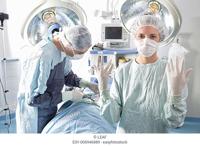 Female doctor asking for gloves in middle of operation