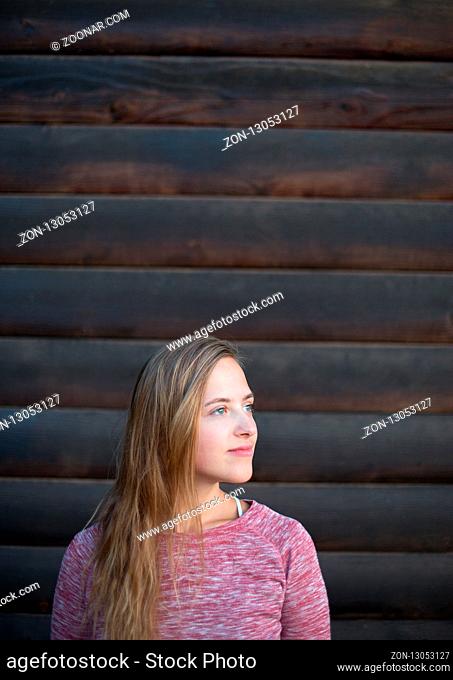 Portrait of Young Hipster Woman on Wooden Wall Background