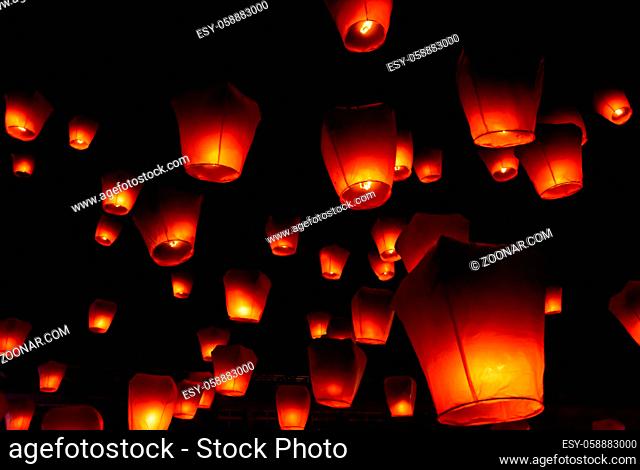 Glowing orange paper lanterns illuminate the night sky during the Pingsi sky lantern festival in Taiwan