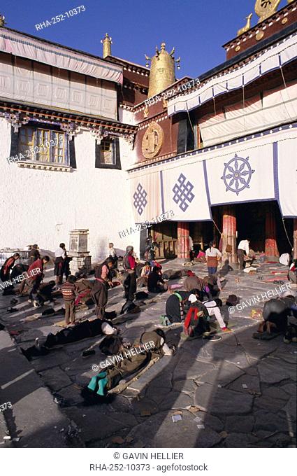 Pilgrims prostrating outside the Jokhang Temple, Lhasa, Tibet, China, Asia