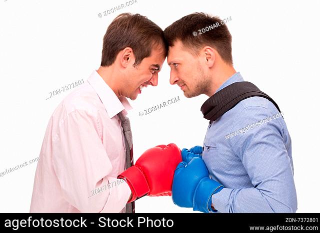 Business battle between two men about corporations. Two men in boxing gloves their heels in