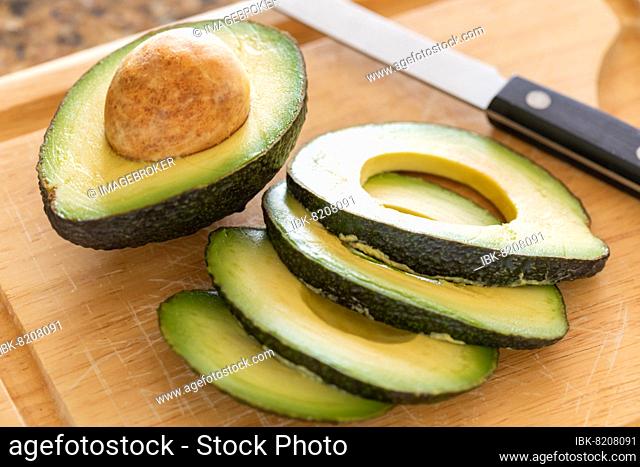 Fresh cut avocado on wooden cutting board