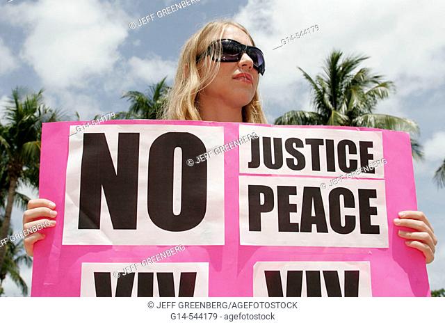 May Day Rally, amnesty, immigration, Iraq War, White female. Torch of Friendship. Biscayne Boulevard. Miami. Florida. USA