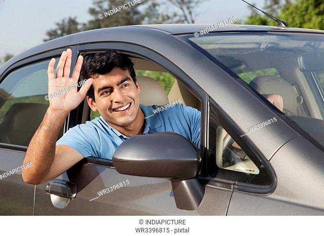 Man waving from his car