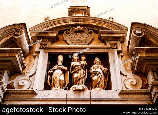 Temple of Santa Grata, Bergamo. High relief on the facade with figures of women, an old man and a baby. High quality photo