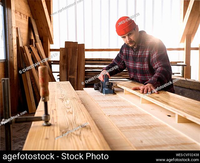 Carpenter working with hand tool at workshop