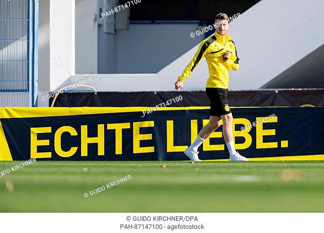 Dortmund's Marco Reus walks by an advertising banner reading ""Echte Liebe"" (lit. ""true love"") during training at the Borussia Dortmund training camp in...