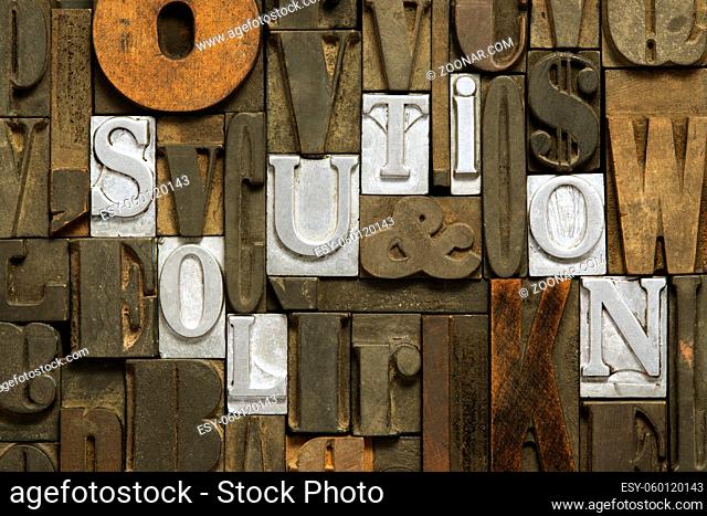 solution concept made from metallic letterpress blocks in mixed wooden letters