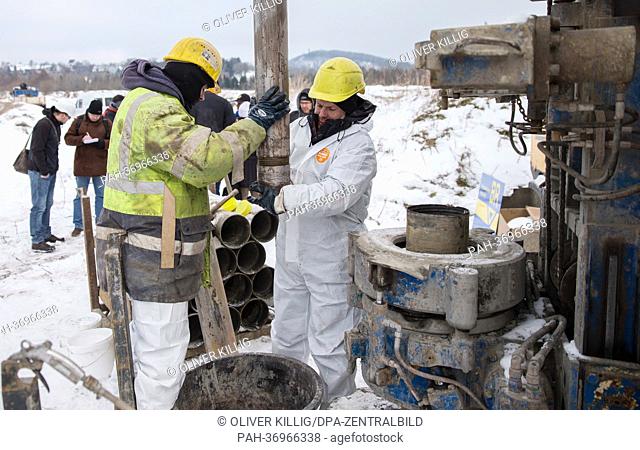 Workers prepare a drill head to drill for samples at a mine dump in Altenberg,  Germany, 11 February 2013. The Helmholtz Research Center in Dresden and the...