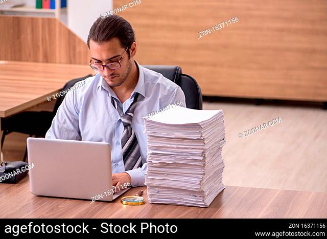 Young employee unhappy with excessive work in the office