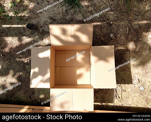 Open cardboard box on a the ground