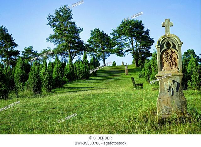 wayside shrines in meadow with stock of junipers, Germany, Rhineland-Palatinate, Eifel, Alendorf
