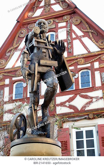Statue of Goetz von Berlichingen by Gunther Stilling in front of the ornate half-timbered building of the Old Town Hall, Jagsthausen an der Jagst, Hohenlohe