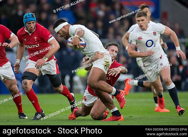07 March 2020, Great Britain, London: Tackling from Josh Navidi (Wales, 8) to Manu Tuilagi (England, 13). On the left Justin Tipuric (Wales, 7)
