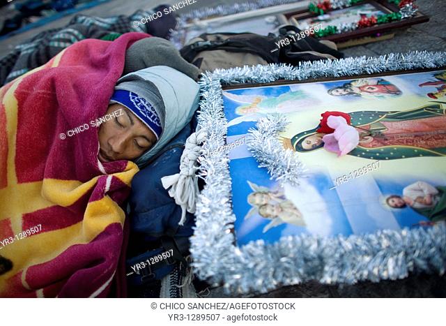 A pilgrim sleeps in the street by an image of the Our Lady of Guadalupe virgin in Mexico City, December 11, 2010  Hundreds of thousands of Mexican pilgrims...