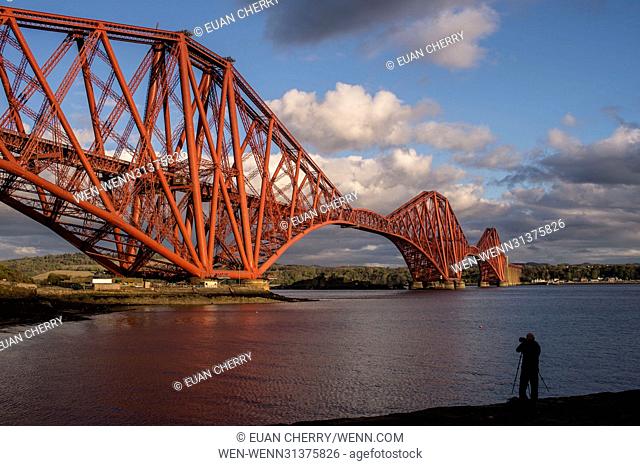 Public takes pictures during Golden Hour at North Queensferry of the Forth Bridge. Featuring: public at Forth Bridge Where: Edinburgh