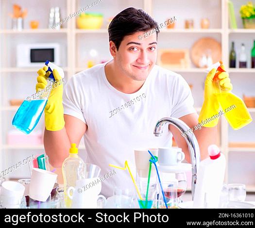 The man enjoying dish washing chores at home