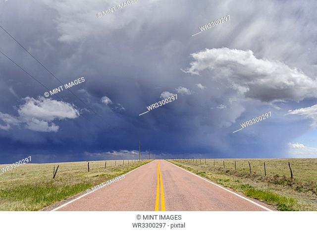 Storm clouds over open road, Rush, Colorado, United States