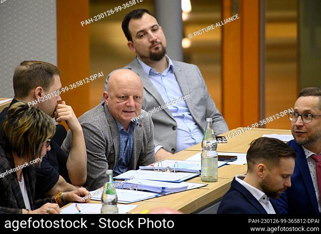 26 January 2023, Saxony-Anhalt, Magdeburg: Hagen Kohl (M, AfD) sits in the plenary chamber of the Saxony-Anhalt state parliament between MPs Jan Moldenhauer (l)...