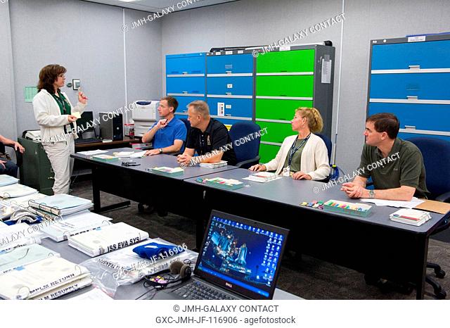 STS-135 crew members participate in a flight data file review in the Flight Operations Facility at NASA's Johnson Space Center