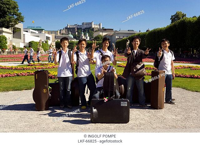 Members of the Asian Youth Orchestra smiling at camera, Mirabell castle and garden, Hohensalzburg Fortress, largest, fully-preserved fortress in central Europe