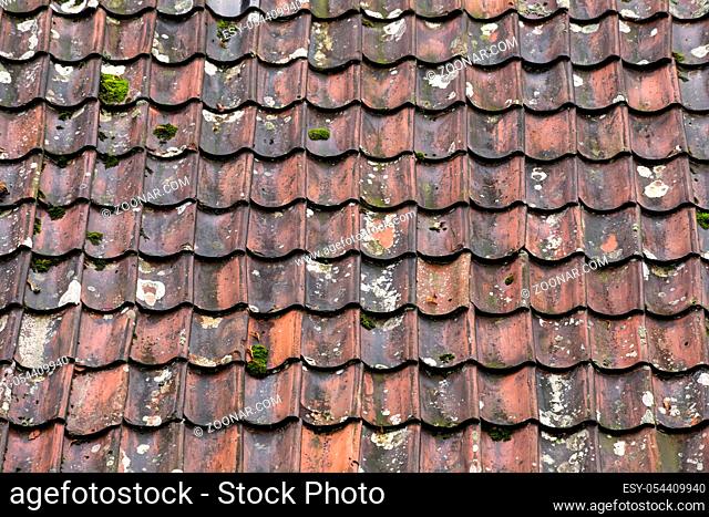 Old and ruined roof tiles close-up. Texture of a roof with old roof tiles. abstract background texture