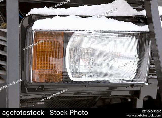 Headlight of a truck on the frozen winter ourdoor - cold outdoor, close up