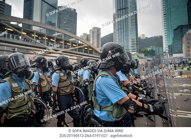 June 12, 2019 - Hong Kong, China - A group of riot police seen with the riot gears and gas masks as they about to use tear gas to push the crowd back