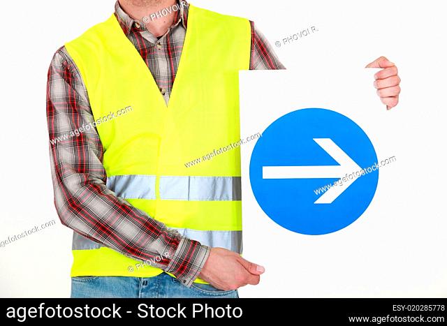 Man holding road sign