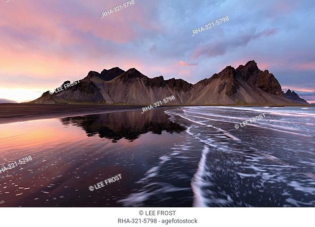 View of the mountains of Vestrahorn from black volcanic sand beach at sunset, Stokksnes, South Iceland, Polar Regions