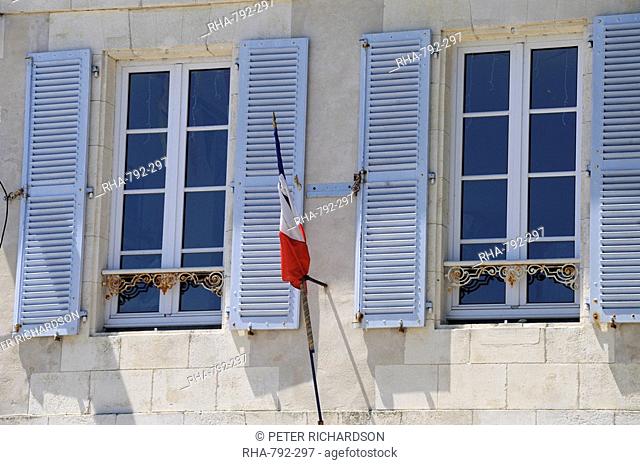 Shuttered windows and French flag, La Flotte, Ile de Re, Charente-Maritime, France, Europe