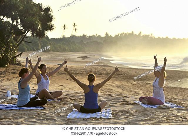 yoga class on the beach beside the Sen Wellness Sanctuary, near Tangalle, South Coast of Sri Lanka, Indian subcontinent, South Asia