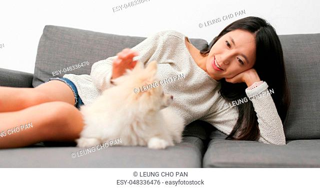 Woman caressing her dog at home