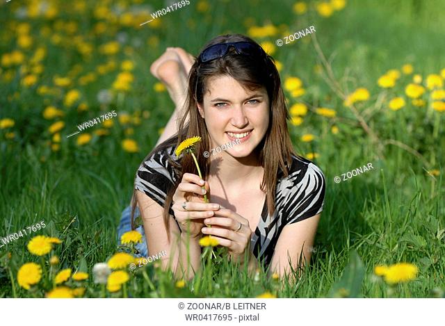 Young woman enjoying the sun on a meadow