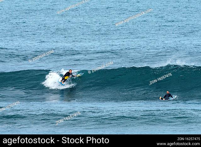 Saint-Jean-de-Luz, P-A / France - 22 October 2020: a middle-aged man surfing on a waveski in the Atlantic Ocean