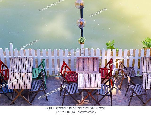 Wooden tables and chairs by the river Tiber (Tevere), Rome, Lazio, Italy, Europe