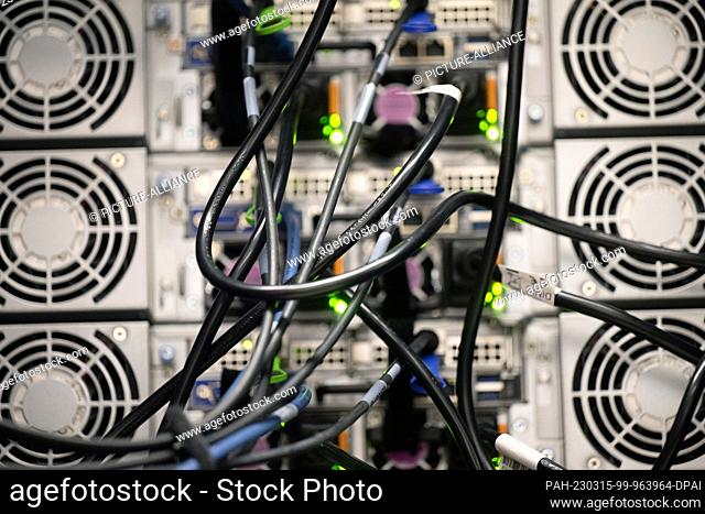13 March 2023, Rhineland-Palatinate, Mainz: Cabling for data and cooling of the high-performance computer are seen during the inauguration ceremony of the new...