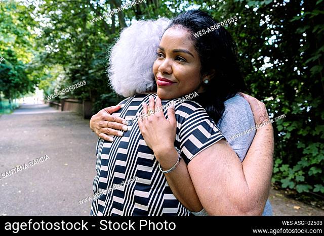 Mother and daughter hugging each other in park