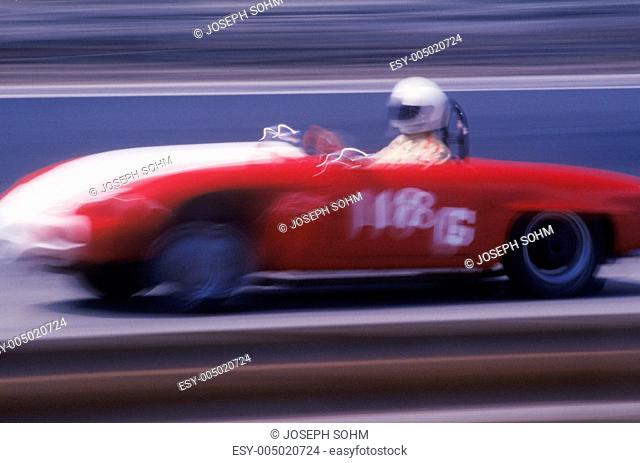 A red car and driver in the Laguna Seca Classic Car Race in Carmel, California