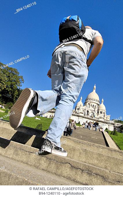 People climbing stairs in front of the Basilica Sacré-Coeur. Montmartre. Paris, France