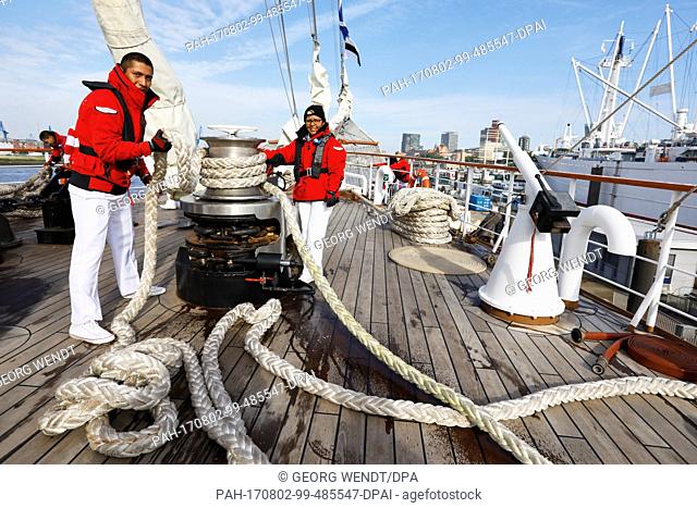 Third sergeant and helmsman, Justo Jack Vasquez (L) and crewmember Alicia Pacacios Rojas tie a mooring line on the Peruvian school ship ""Union"" in the harbour...